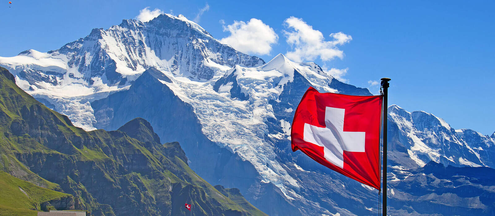 Schweizer Flagge vor dem Berg Jungfrau in der Schweiz © swisshippo - stock.adobe.com