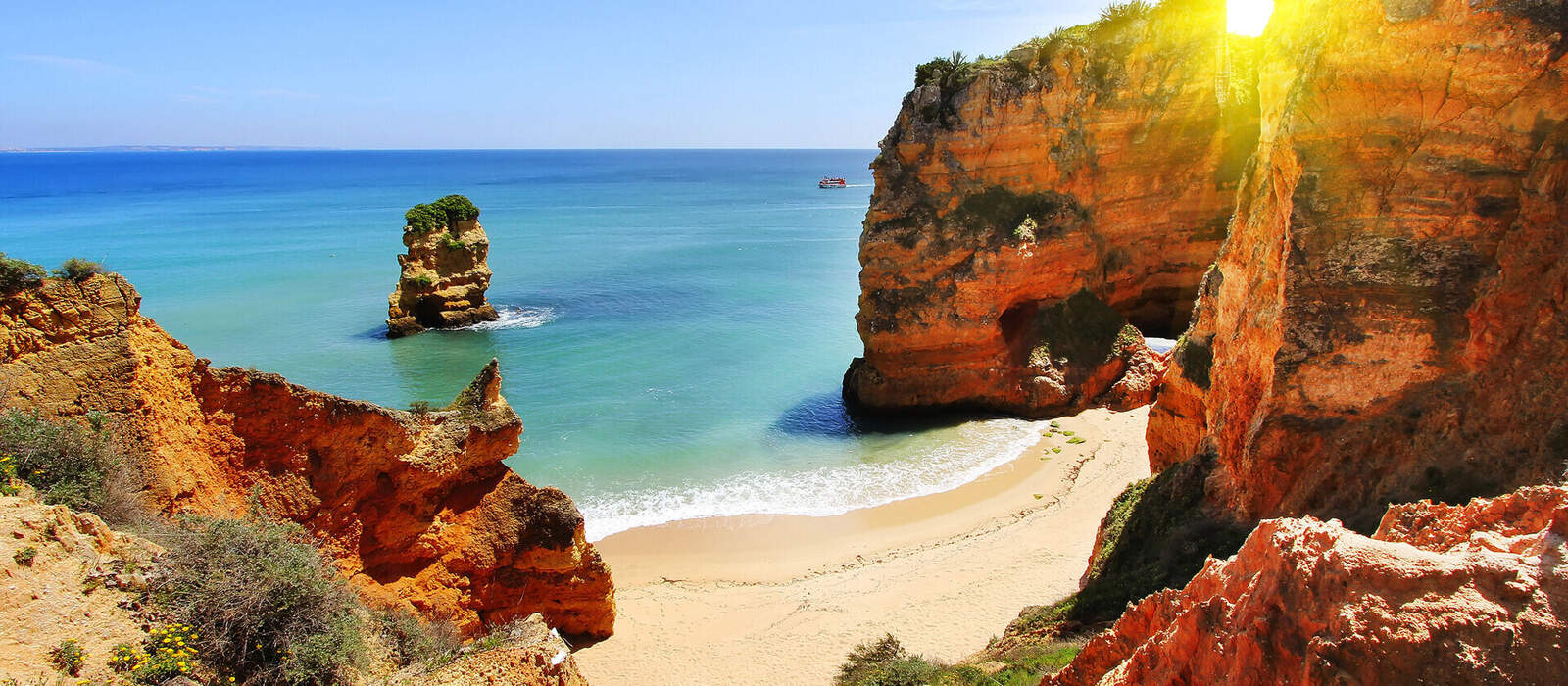 Rocky beach at sunset, Lagos, Portugal. Counter light. Travel and business background © sergeialyoshin - stock.adobe.com